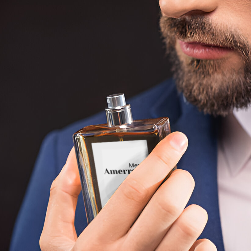 a man in a suit holding a bottle of perfume
